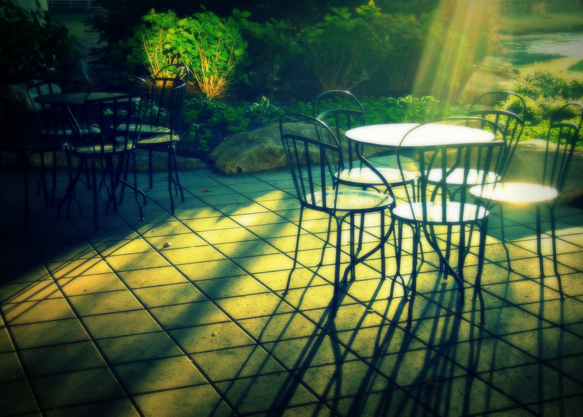 Photograph of patio. Floor paved with square tiles.