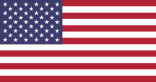 American flag. 13 stripes, 7 red, 6 white. Blue rectangle, top left corner. 50 white stars in blue rectangle.