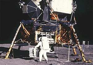 A photograph of an astronaut next to the Lunar Module.