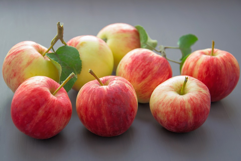eight red apples on neutral background