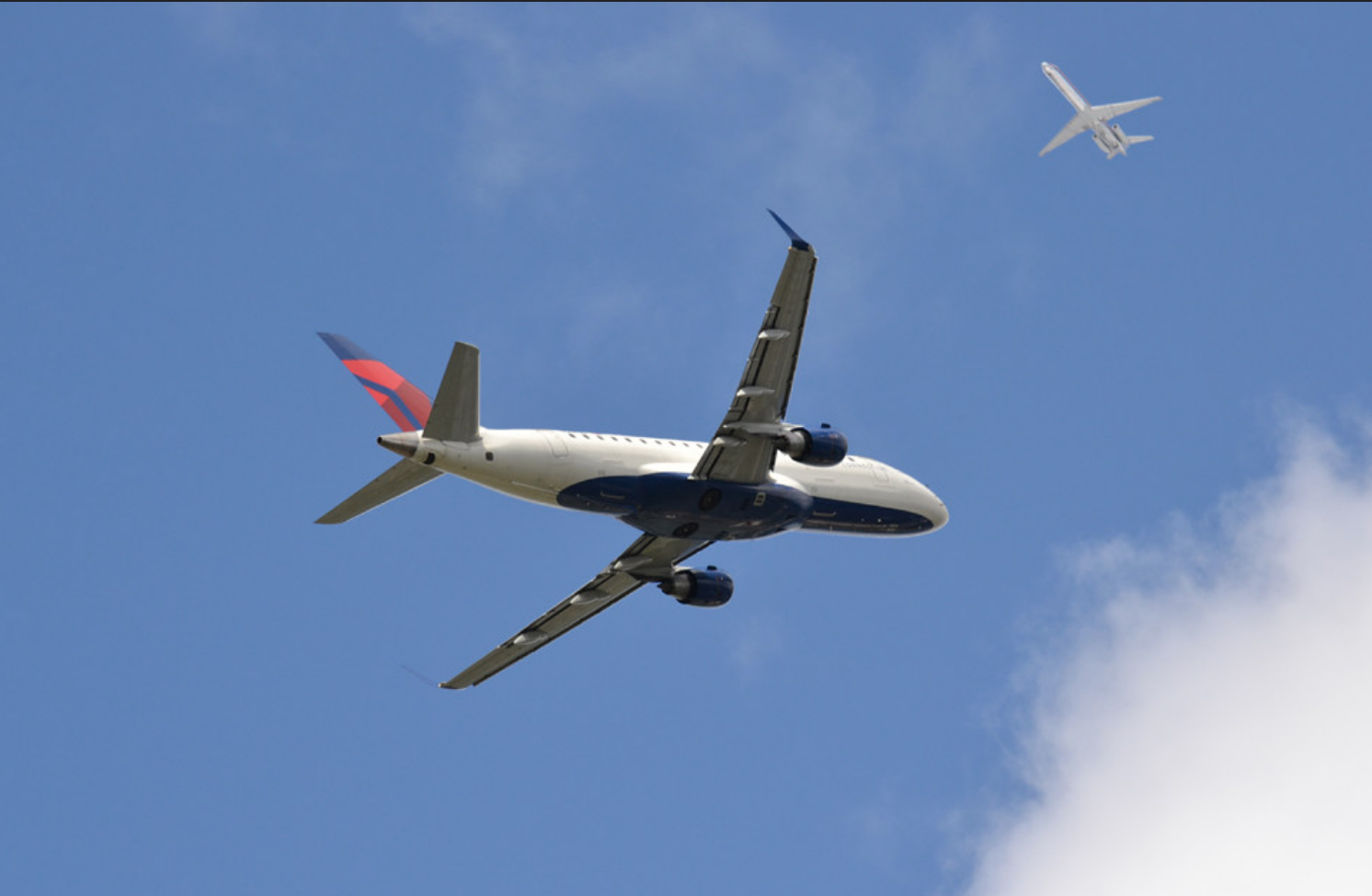 Photograph, airplane in sky.