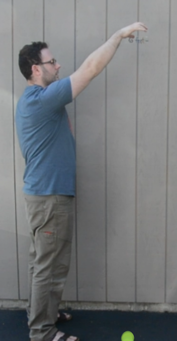 A man dropping a ball.