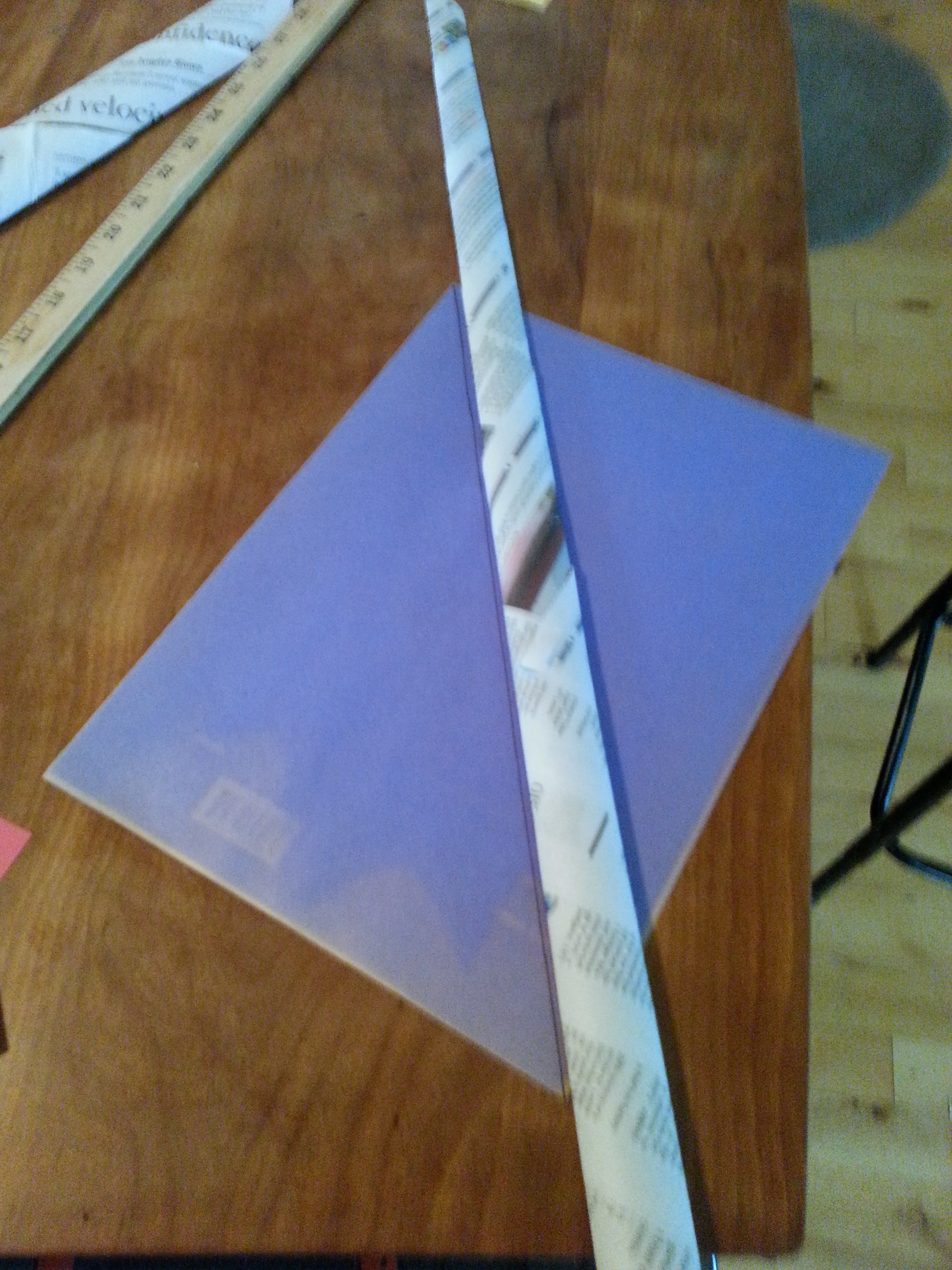 An image looking at down on a corner of a table with items on the table.