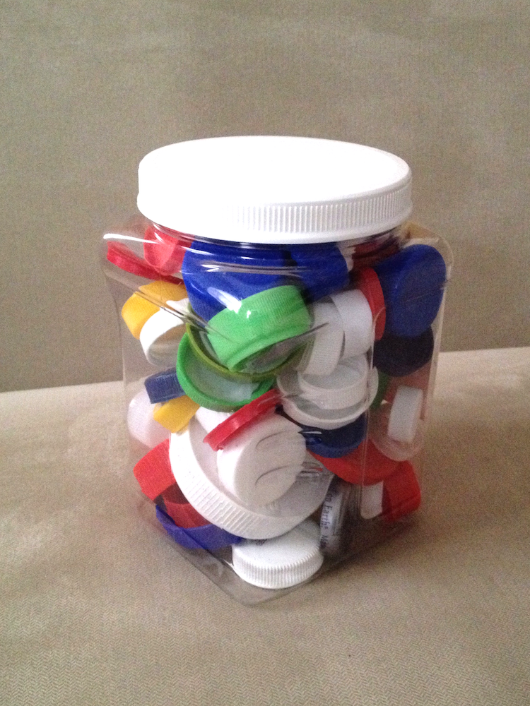 A photo of a jar of bottle caps.