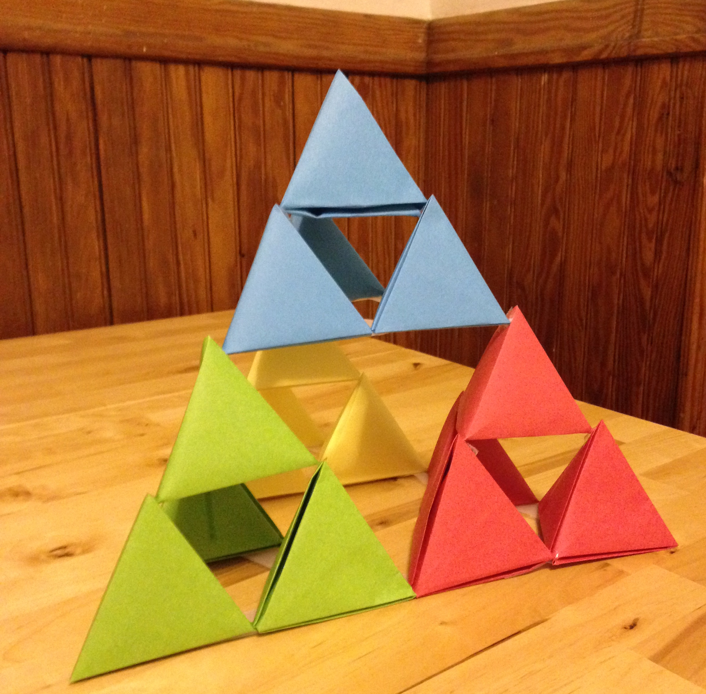 A large tetrahedron composed of various colors of smaller tetrahedra.