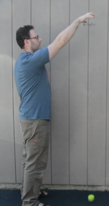 A man dropping a ball.