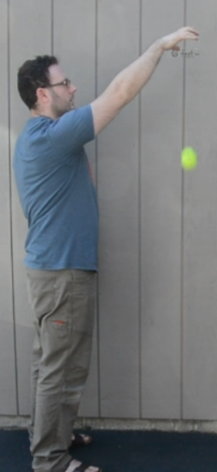 A man dropping a ball.