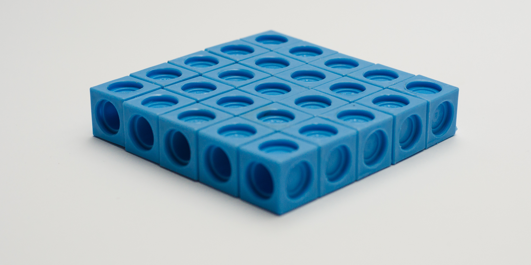 A photo of a prism made up of interlocking cubes. Each side is 5 cubes long. The prism is 1 cube tall.