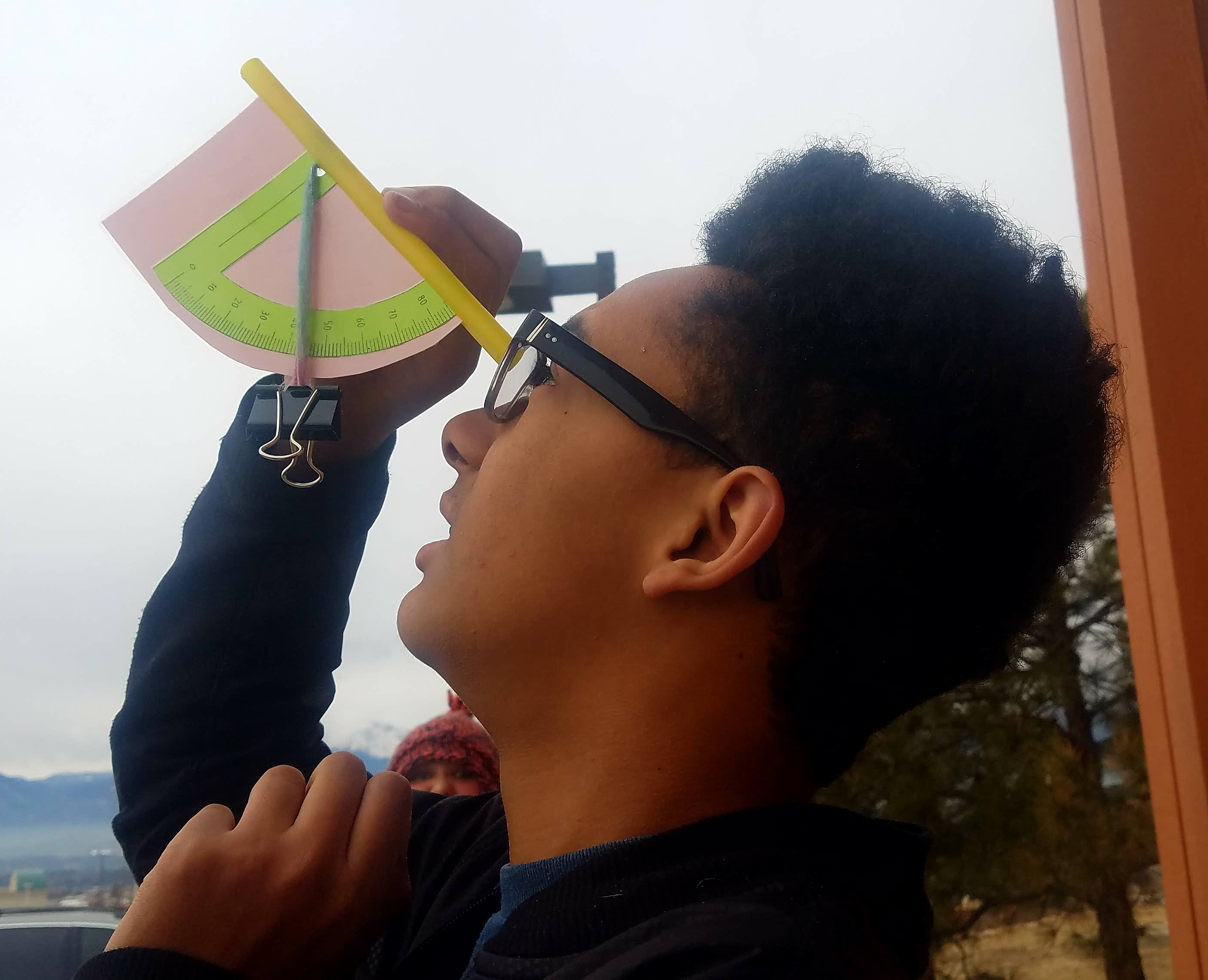 Student with handmade clinometer.