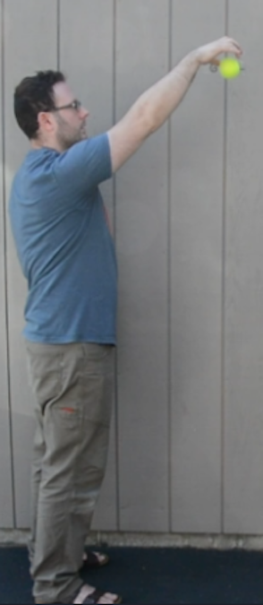 A man dropping a ball.