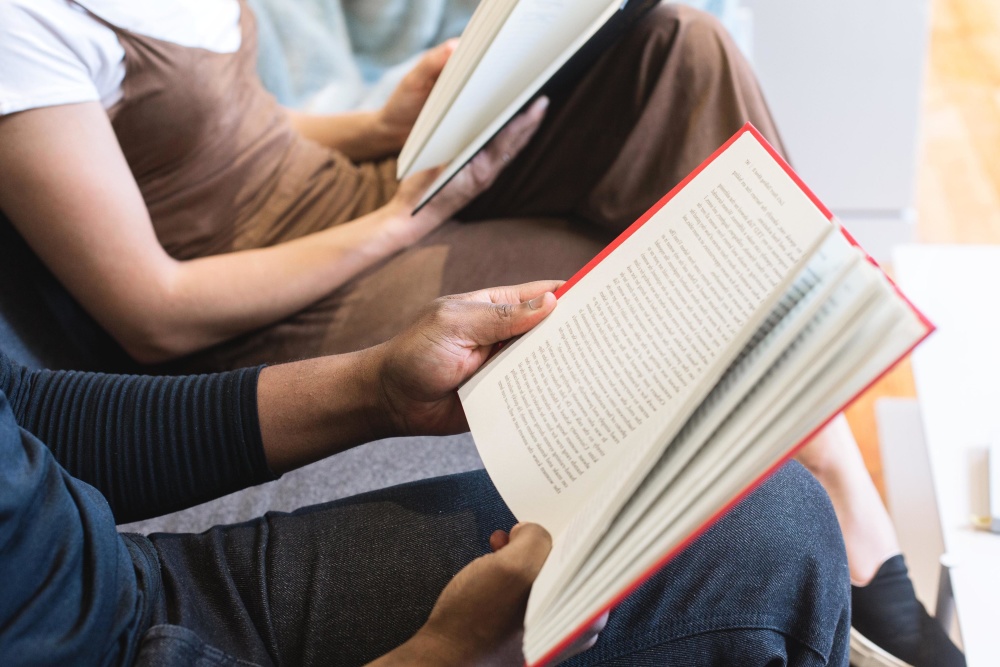 Two students reading while sitting