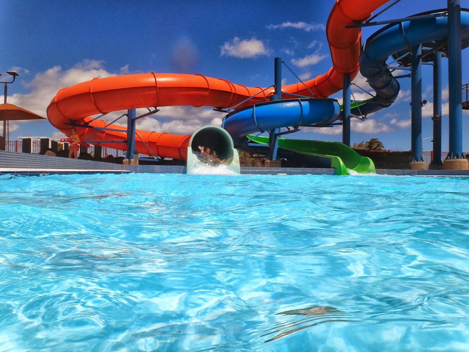 a photo of slides and a pool at a water park