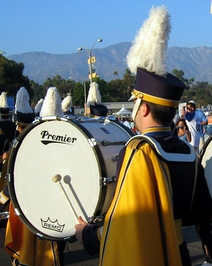 Photograph of a man playing a drum in a marching band