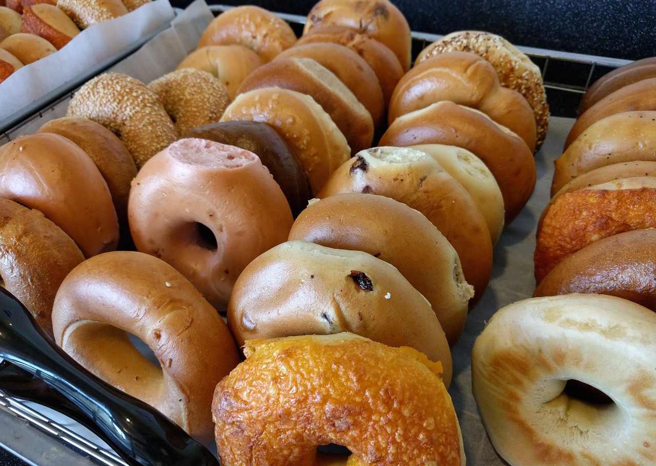 Trays of bagels at a bagel shop.