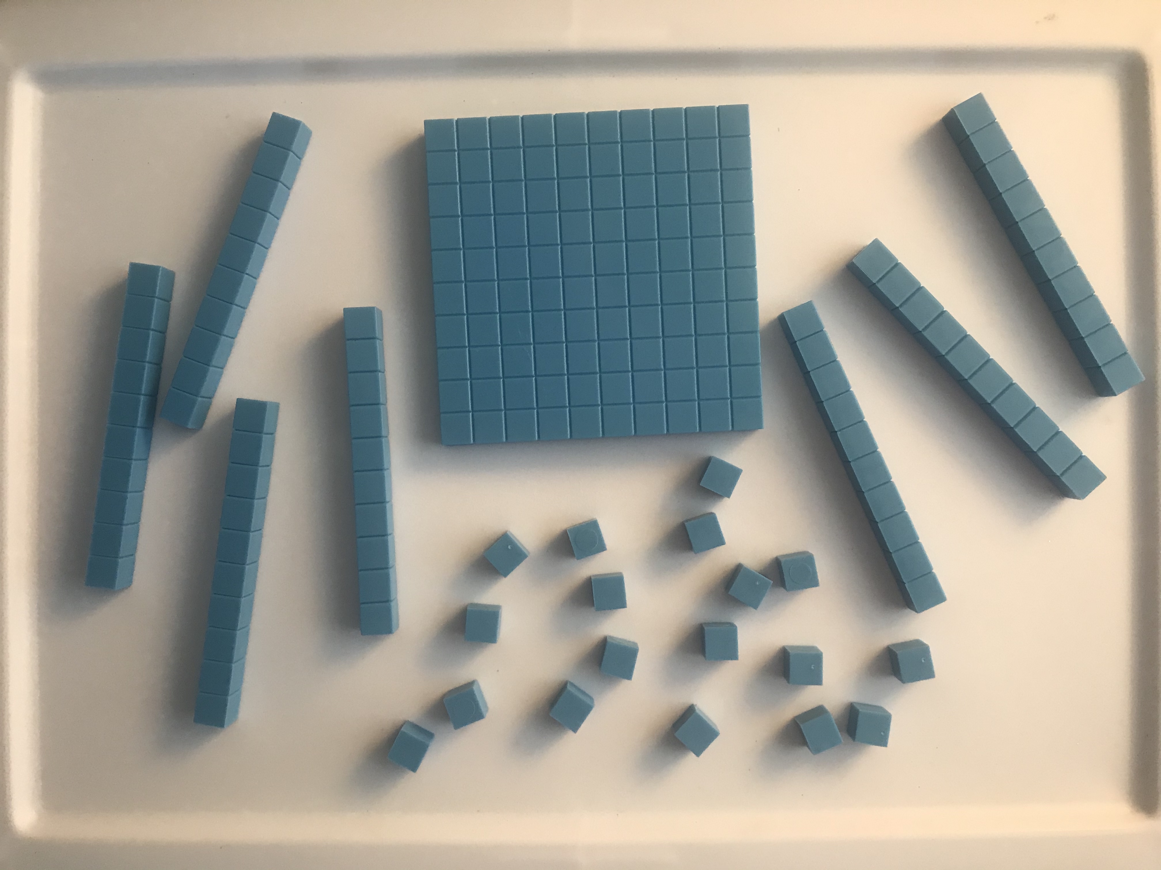 Base-ten blocks. 1 hundred, 7 tens, 18 ones.