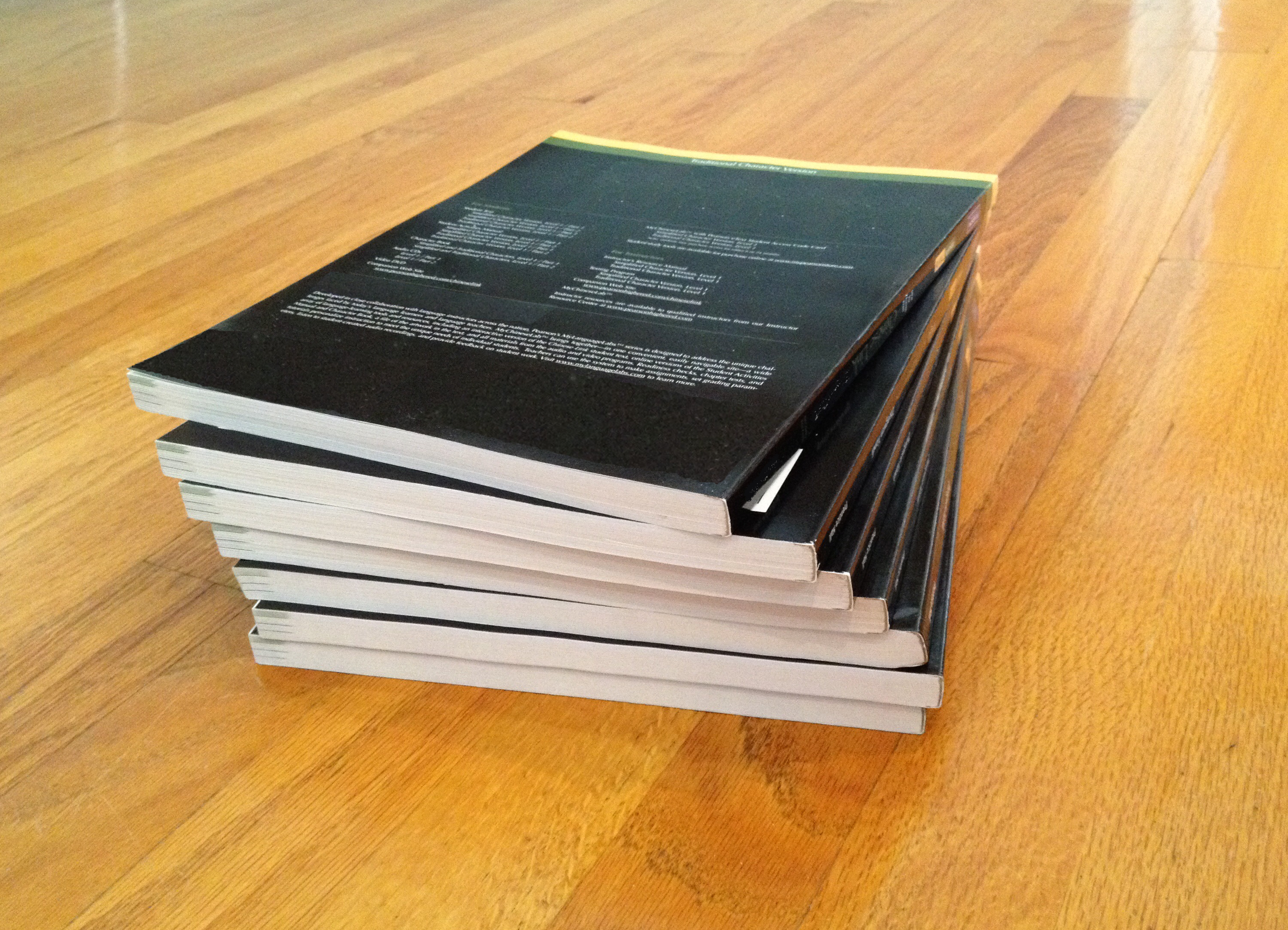 Photograph of a stack of 7 notebooks.