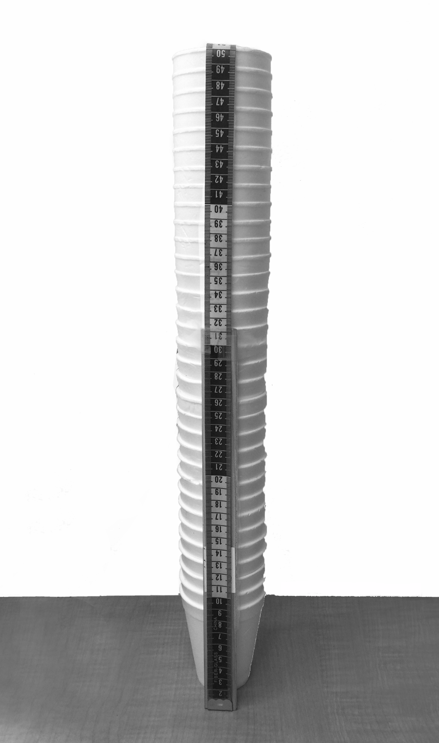 Measuring tape used to measure stack of styrofoam cups