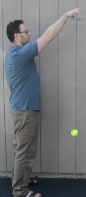 A man dropping a ball.