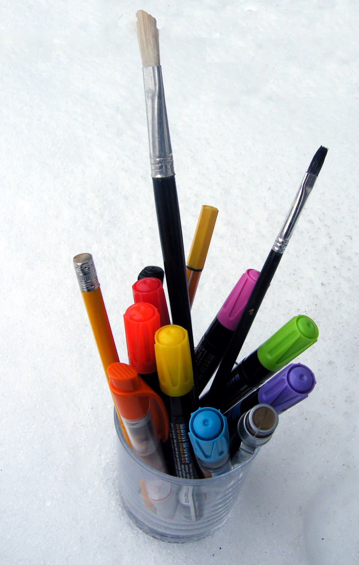 Pens and pencils in a cup.