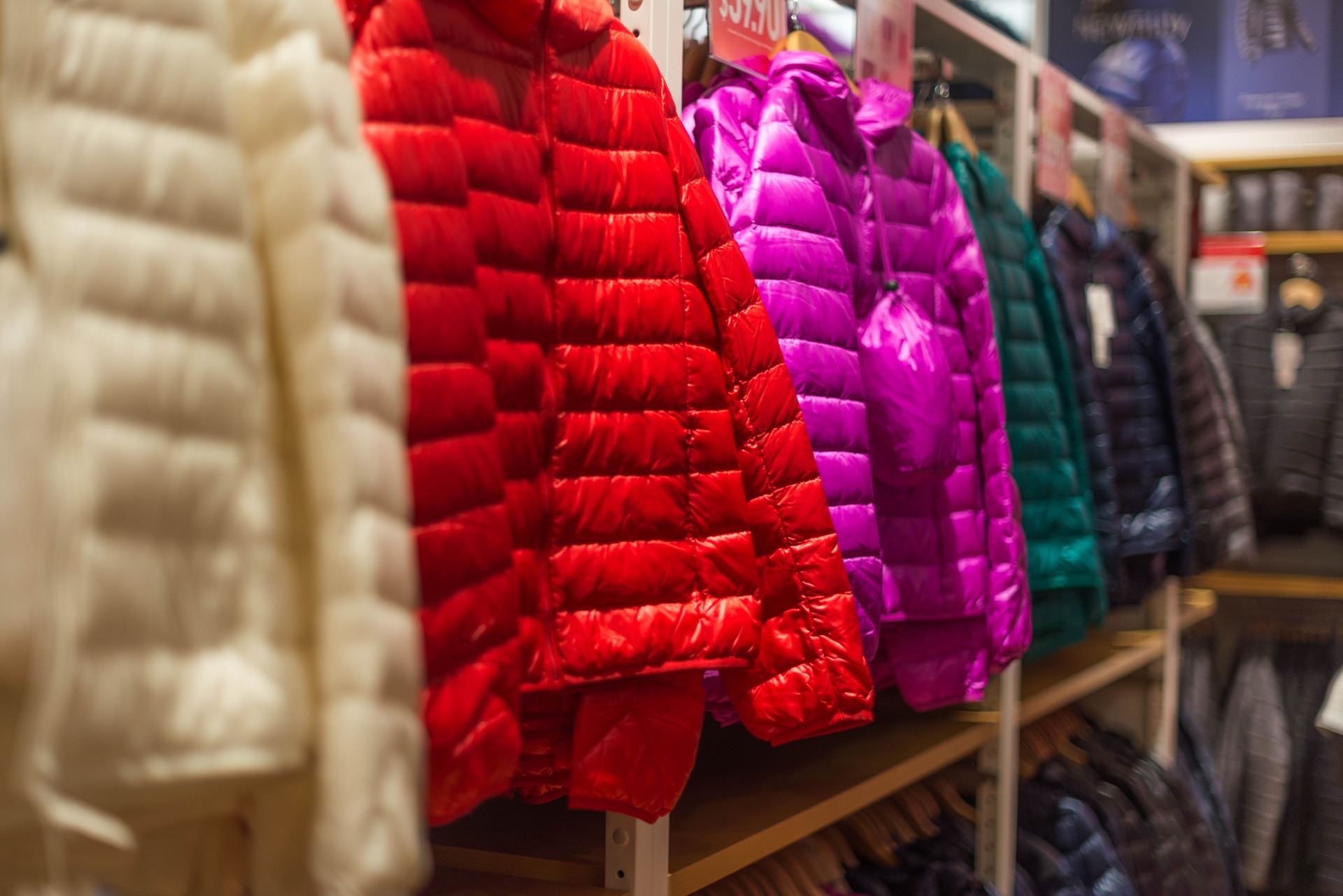 a photo of down jackets hanging in a store