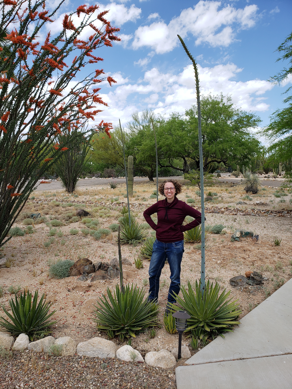 woman next to tall agave plant