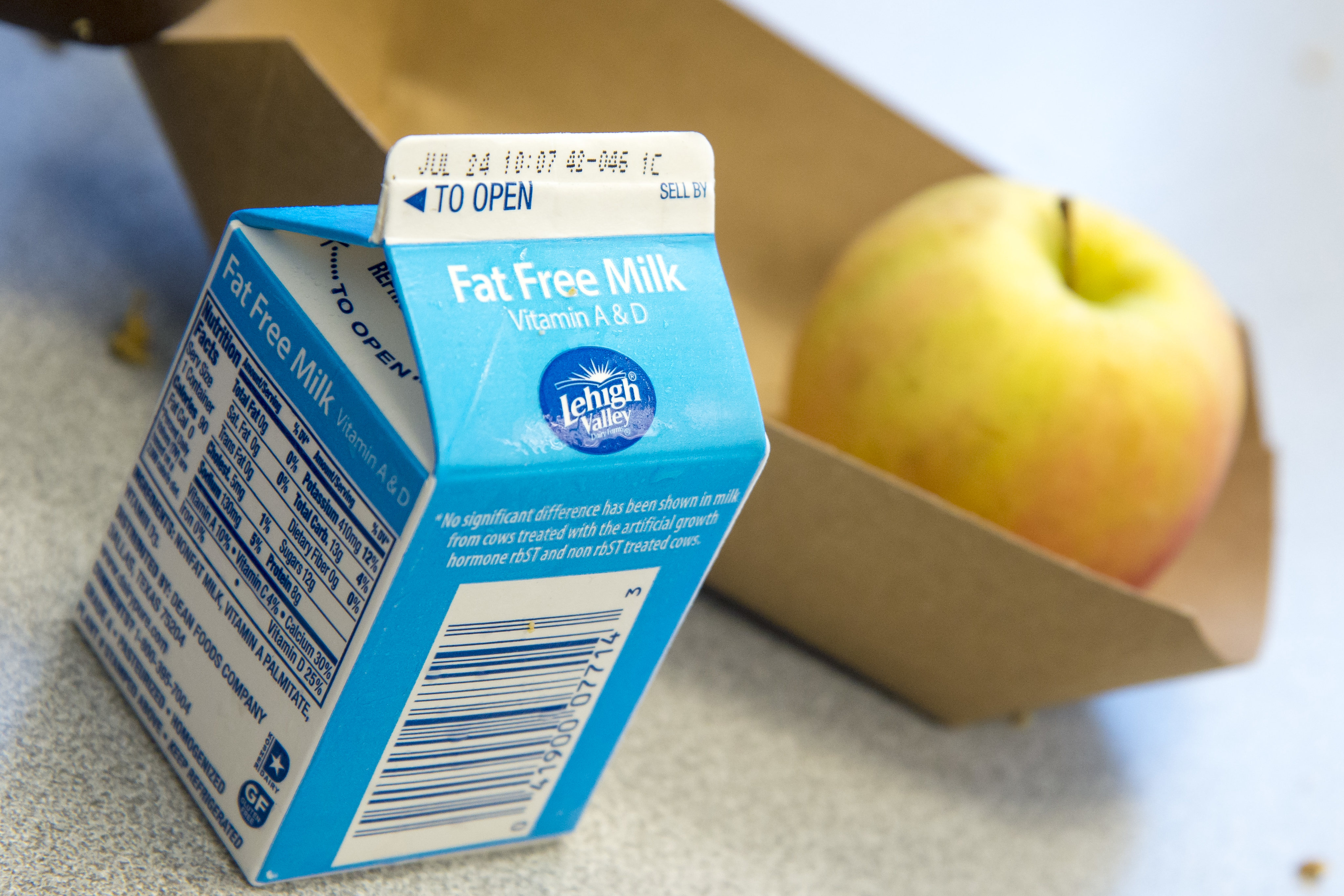 photograph of a milk carton that is a little larger than an apple