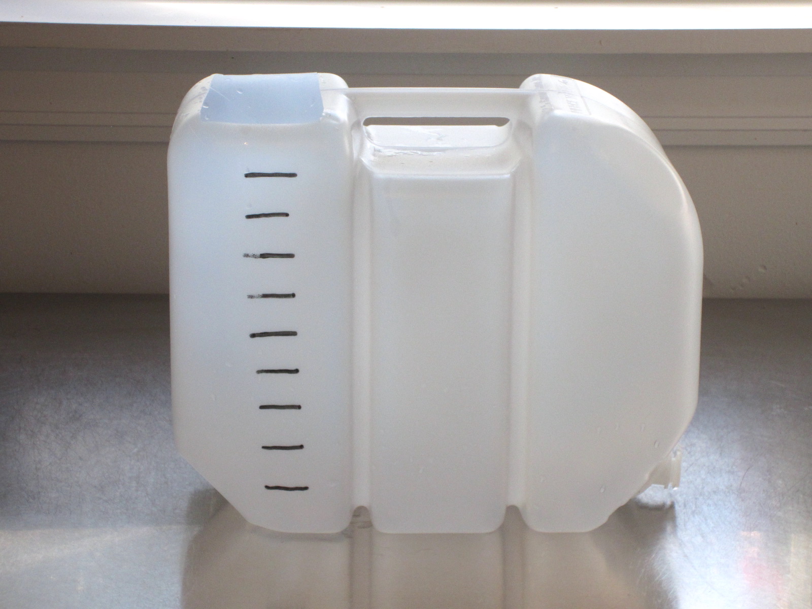 Empty jug with lines for measurement.