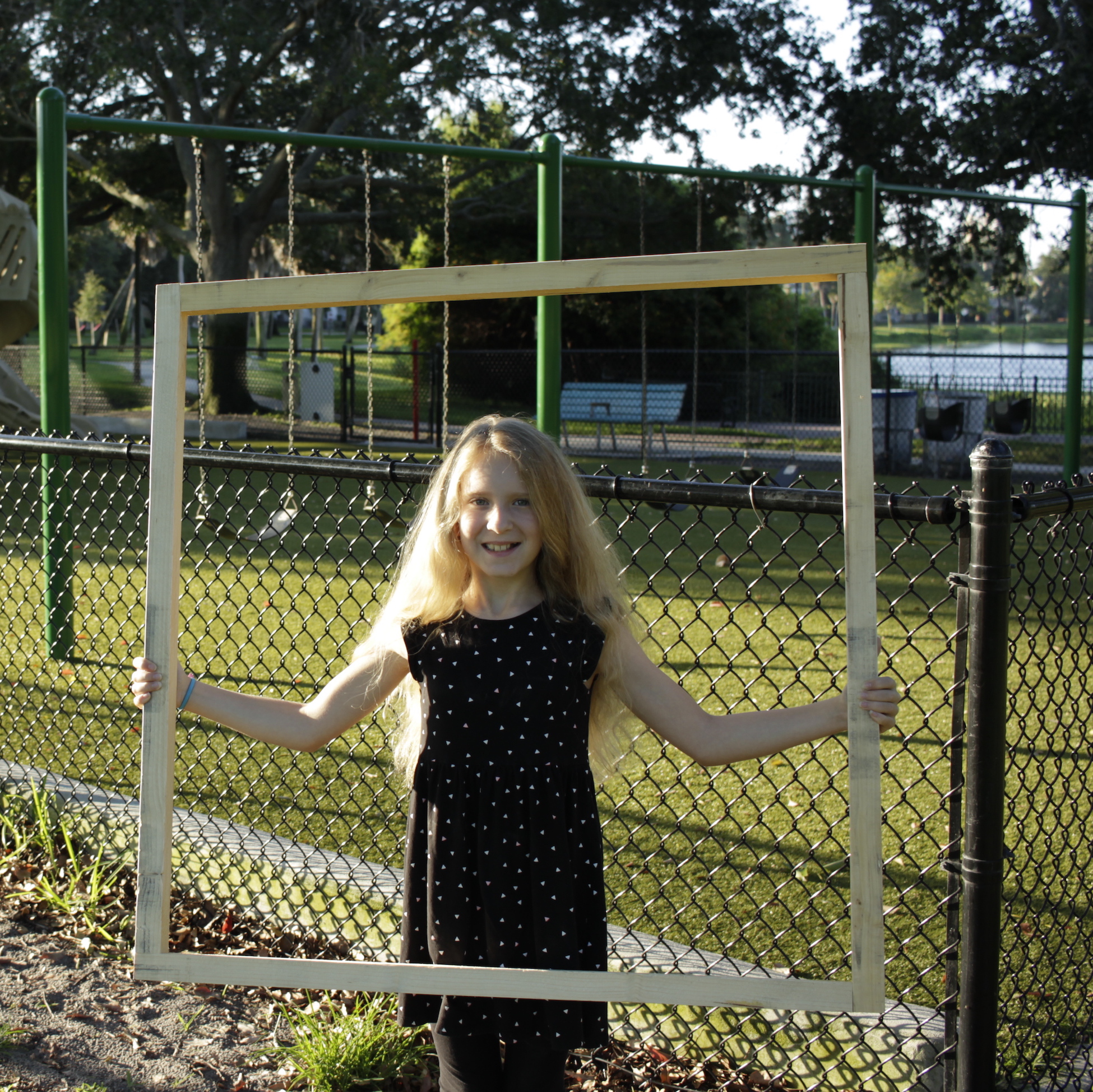 Girls holding a square meter frame.
