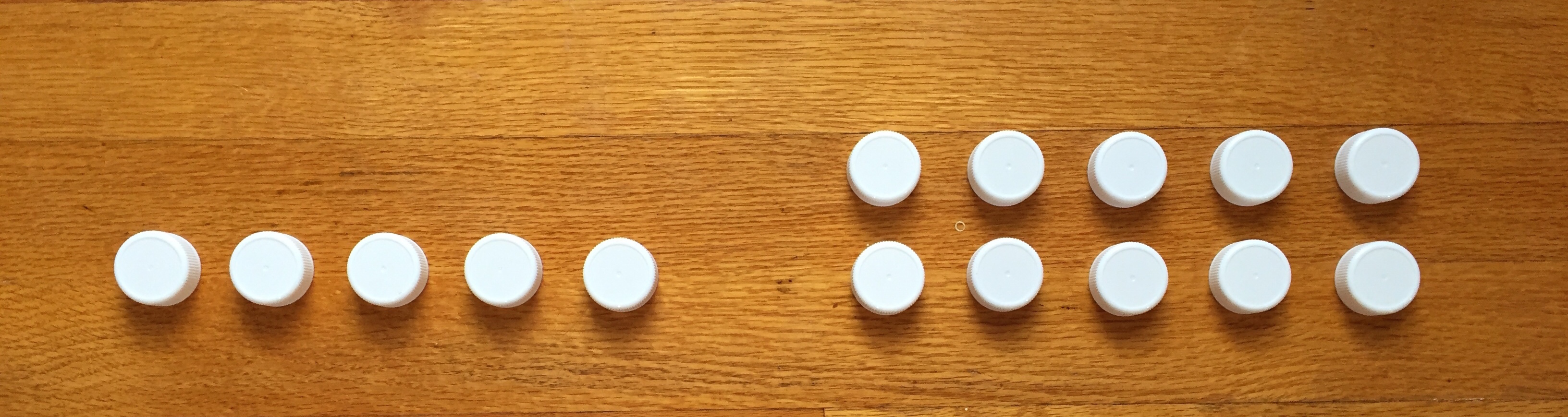 photo of bottle caps lined up. On the left, 1 row of 5 bottle caps. On the right, 2 rows of 5 bottle caps.