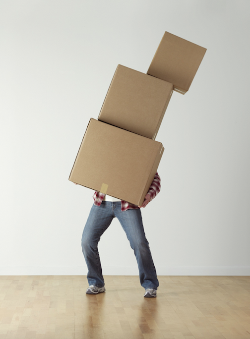 man balancing different sized boxes