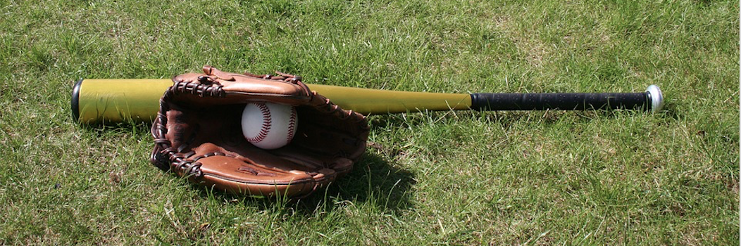 baseball, glove, and bat on grass